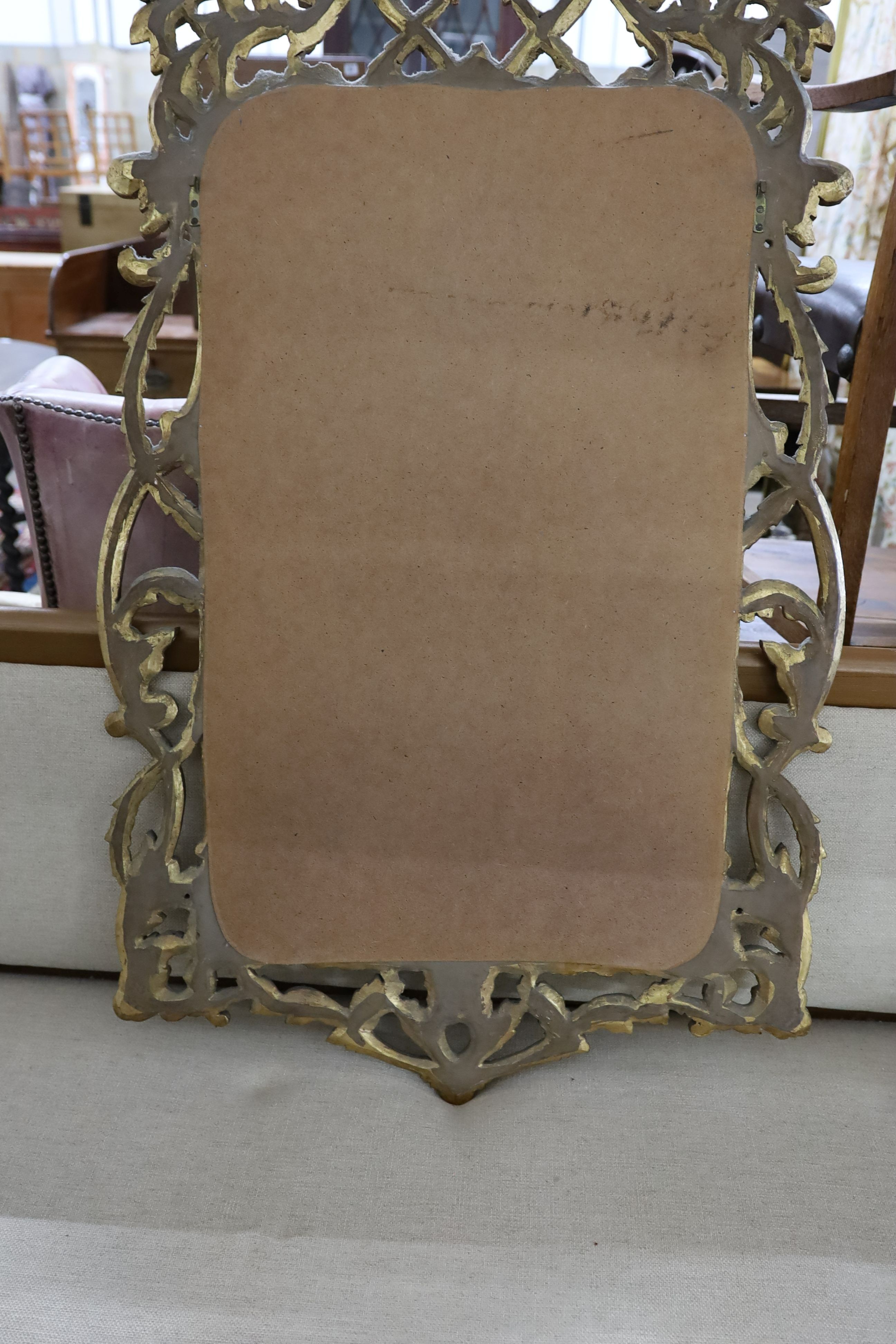 An 18th century style carved giltwood scrollwork mirror, width 64cm, height 132cm